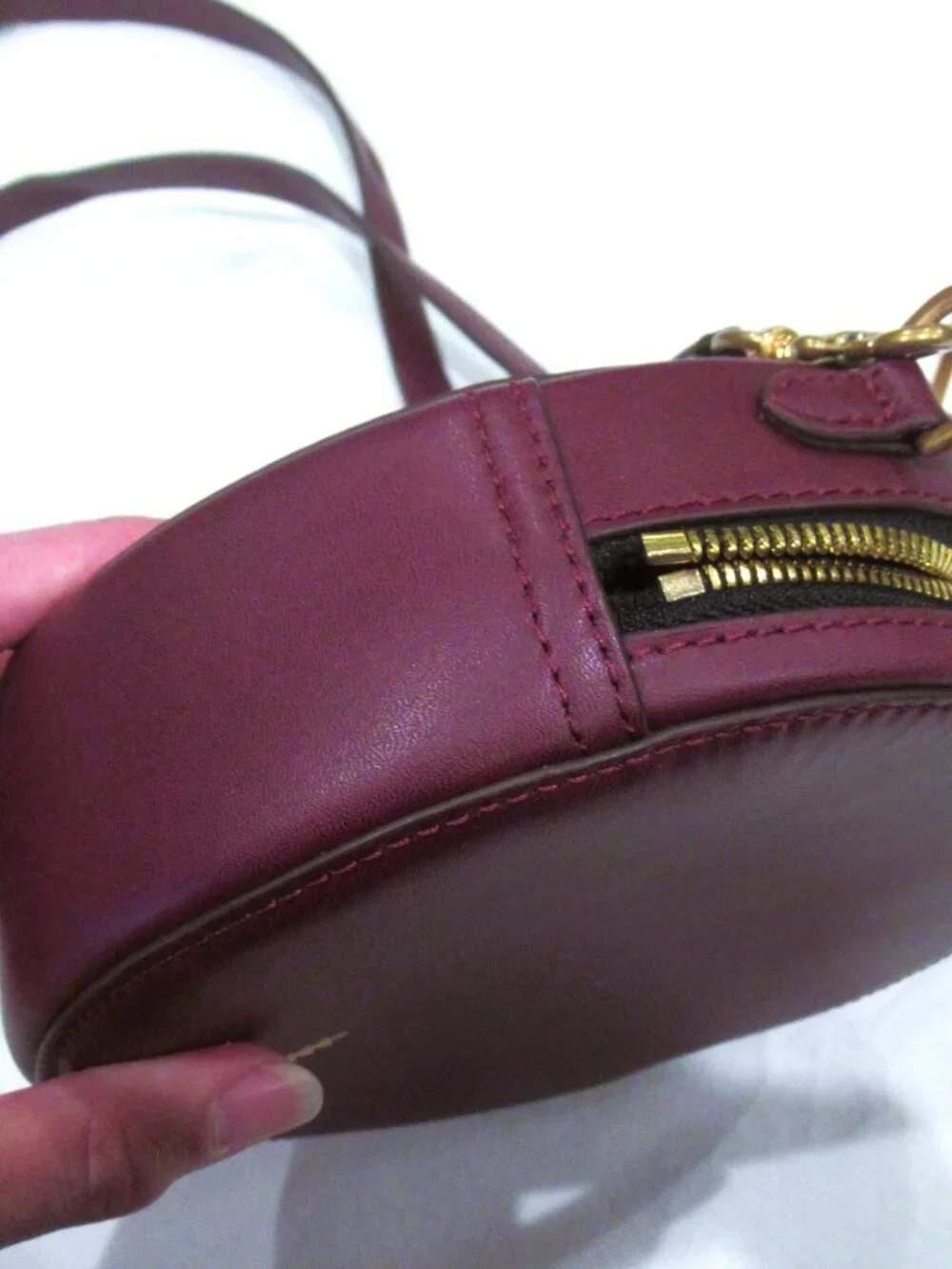 Thacker burgundy purse, both a crossbody and a bracelet handle